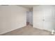 Neutral bedroom with carpet, white walls, two doors, and natural light from the window at 1766 Falls Cove Rd, Newton, NC 28658