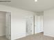 Spacious bedroom featuring neutral carpet, white walls, and multiple doorways at 1766 Falls Cove Rd, Newton, NC 28658