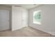 Cozy bedroom with soft carpeting, a window with blinds, and a crisp, clean aesthetic at 1766 Falls Cove Rd, Newton, NC 28658