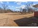 Large backyard with mature trees and open space, offering privacy and potential at 200 11Th St, Spencer, NC 28159
