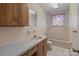 Pink bathroom with tub and wood vanity at 200 11Th St, Spencer, NC 28159