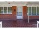 Home's entrance with brick facade and white door at 200 11Th St, Spencer, NC 28159