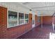 Brick front porch with tiled flooring and covered area at 200 11Th St, Spencer, NC 28159