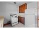 White appliances and wood cabinets at 200 11Th St, Spencer, NC 28159