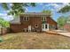 Brick home back exterior view complete with wooden deck, grill, and landscaped lawn at 2000 Shannon Bridge Ln, Matthews, NC 28105