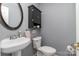 Clean bathroom with pedestal sink and dark wood cabinet at 2000 Shannon Bridge Ln, Matthews, NC 28105