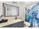 Stylish bathroom featuring a large mirror, vanity with storage, and a vibrant blue shower curtain at 2000 Shannon Bridge Ln, Matthews, NC 28105