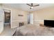 Spacious bedroom with neutral paint, ceiling fan, and access to a walk-in closet for ample storage at 2000 Shannon Bridge Ln, Matthews, NC 28105