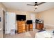 Well-lit bedroom with two dressers and a ceiling fan at 2000 Shannon Bridge Ln, Matthews, NC 28105