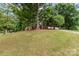 Beautiful home nestled amongst mature trees on a grassy hill with a private driveway at 2000 Shannon Bridge Ln, Matthews, NC 28105