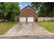 Spacious two-car garage with a brick exterior and long driveway at 2000 Shannon Bridge Ln, Matthews, NC 28105