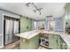 Eat-in kitchen with granite counters, kitchen island, stainless appliances and a sliding barn door to pantry at 2000 Shannon Bridge Ln, Matthews, NC 28105