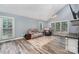 Spacious living room featuring vaulted ceiling, large windows, and wood-look flooring throughout at 2000 Shannon Bridge Ln, Matthews, NC 28105