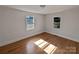 Well-lit bedroom featuring hardwood floors and two windows at 2042 Country Ct, Rock Hill, SC 29732