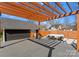 Backyard deck and outdoor dining with a wooden pergola and detached garage at 212 Bacon Ave, Charlotte, NC 28208