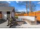 Backyard featuring a stone fire pit with built-in seating and a detached garage at 212 Bacon Ave, Charlotte, NC 28208
