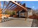 Backyard deck with outdoor dining and a wooden pergola at 212 Bacon Ave, Charlotte, NC 28208