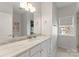 Bathroom featuring single vanity with marble countertop and gray cabinets at 212 Bacon Ave, Charlotte, NC 28208