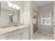 Bright bathroom features a marble countertop vanity and glass-enclosed shower at 212 Bacon Ave, Charlotte, NC 28208
