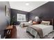 Bedroom features hardwood floors, dark walls, two twin beds, and natural light from window at 212 Bacon Ave, Charlotte, NC 28208