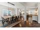 Dining room features a long wood table, modern light fixture, and hardwood floors at 212 Bacon Ave, Charlotte, NC 28208