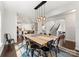 Dining room features a modern light fixture, large table, and access to the staircase at 212 Bacon Ave, Charlotte, NC 28208