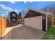 Rear exterior with a detached garage, stone patio, and a wooden fence at 212 Bacon Ave, Charlotte, NC 28208