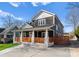 Charming two-story home with a welcoming front porch and wooden fence at 212 Bacon Ave, Charlotte, NC 28208