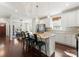 Bright kitchen featuring an island with bar seating, granite countertops, and stainless appliances at 212 Bacon Ave, Charlotte, NC 28208