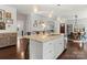 Open-concept kitchen with a granite island, stainless steel appliances, and hardwood floors at 212 Bacon Ave, Charlotte, NC 28208