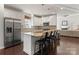 Spacious kitchen featuring a granite island with bar stools and stainless steel appliances at 212 Bacon Ave, Charlotte, NC 28208