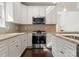 Well-lit kitchen features granite countertops, stainless steel appliances, and white cabinetry at 212 Bacon Ave, Charlotte, NC 28208
