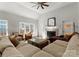 Sunlit living room featuring a cozy fireplace, hardwood floors, and comfortable seating at 212 Bacon Ave, Charlotte, NC 28208