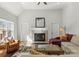 Bright living room featuring a modern fireplace, hardwood floors, and large windows at 212 Bacon Ave, Charlotte, NC 28208