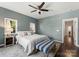 Cozy bedroom with a ceiling fan, soft natural light, and stylish decor at 212 Bacon Ave, Charlotte, NC 28208