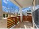 Covered porch with wooden railings and a view of the neighborhood at 212 Bacon Ave, Charlotte, NC 28208