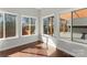 Bright sunroom with hardwood floors and multiple windows offering natural light at 212 Bacon Ave, Charlotte, NC 28208