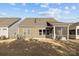 A view of the house and spacious backyard. The outdoor patio offers a relaxing space at 240 Portrait Way # 87, Indian Trail, NC 28079