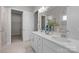 Bright bathroom features double sinks, a large mirror, and access to the walk-in closet at 240 Portrait Way # 87, Indian Trail, NC 28079