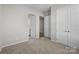 Neutral bedroom with plush carpet, double closets, and doorways leading to other rooms at 240 Portrait Way # 87, Indian Trail, NC 28079