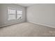 Bedroom with carpet, neutral walls, and large windows that bring in natural light at 240 Portrait Way # 87, Indian Trail, NC 28079