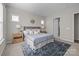Comfortable bedroom featuring a queen bed, stylish area rug, and soft, neutral decor at 240 Portrait Way # 87, Indian Trail, NC 28079
