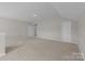 Large bonus room with neutral carpet, two doors, and access to the bathroom at 240 Portrait Way # 87, Indian Trail, NC 28079