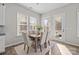 Bright dining area featuring a wooden table, comfortable seating, a decorative rug, and natural light at 240 Portrait Way # 87, Indian Trail, NC 28079