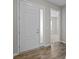 Bright foyer with hardwood floors, a glass-paneled front door, and views into a carpeted room at 240 Portrait Way # 87, Indian Trail, NC 28079
