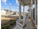Charming front porch with rocking chairs, offering a relaxing view of the neighborhood at 240 Portrait Way # 87, Indian Trail, NC 28079