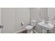 Half-bathroom featuring a modern pedestal sink and toilet, and stylish flooring at 240 Portrait Way # 87, Indian Trail, NC 28079