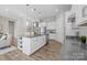 Lovely kitchen featuring a large island, stainless steel appliances, ample cabinet space and modern finishes at 240 Portrait Way # 87, Indian Trail, NC 28079