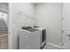 Laundry room boasts modern washer and dryer, overhead shelving, and decorative flooring at 240 Portrait Way # 87, Indian Trail, NC 28079