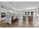 Open-concept space with kitchen island, dining area, and a cozy living room with natural light at 240 Portrait Way # 87, Indian Trail, NC 28079